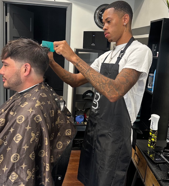 Barber in apron working